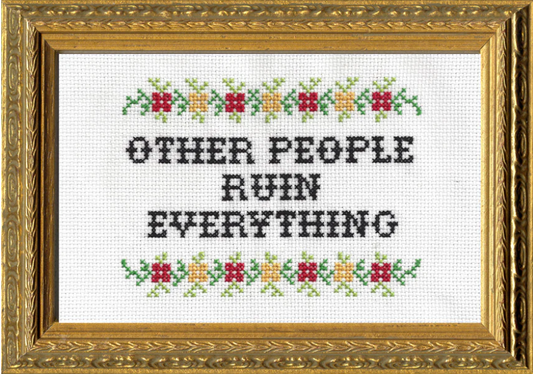 Finished cross stitch kit that says "Other People Ruin Everything" and has floral accents at the top. It is framed in an ornate gold frame.