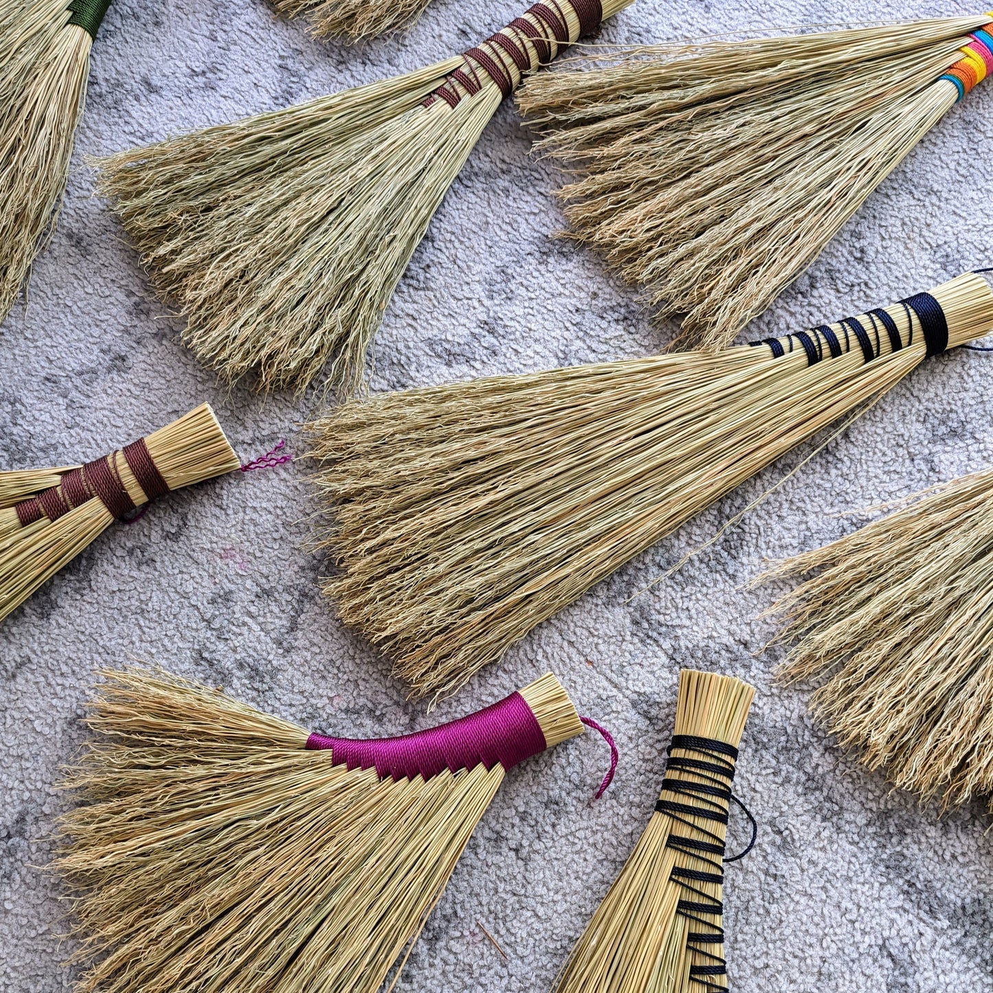 Examples of and brooms laid out on the floor.