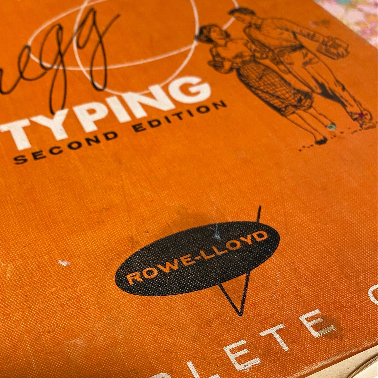 A hardcover book with an orange cover called: Typing Second Edition - that was turned into an art journal.