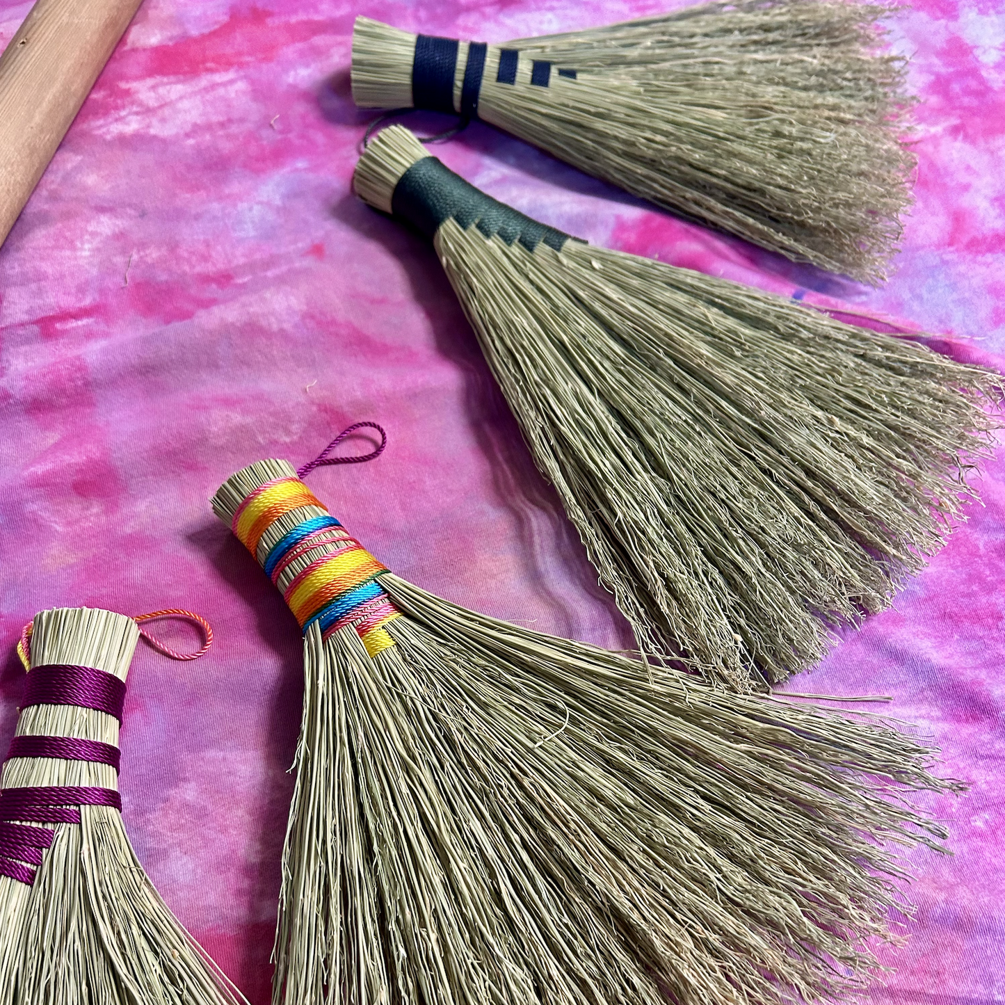 Four examples of hand brooms.