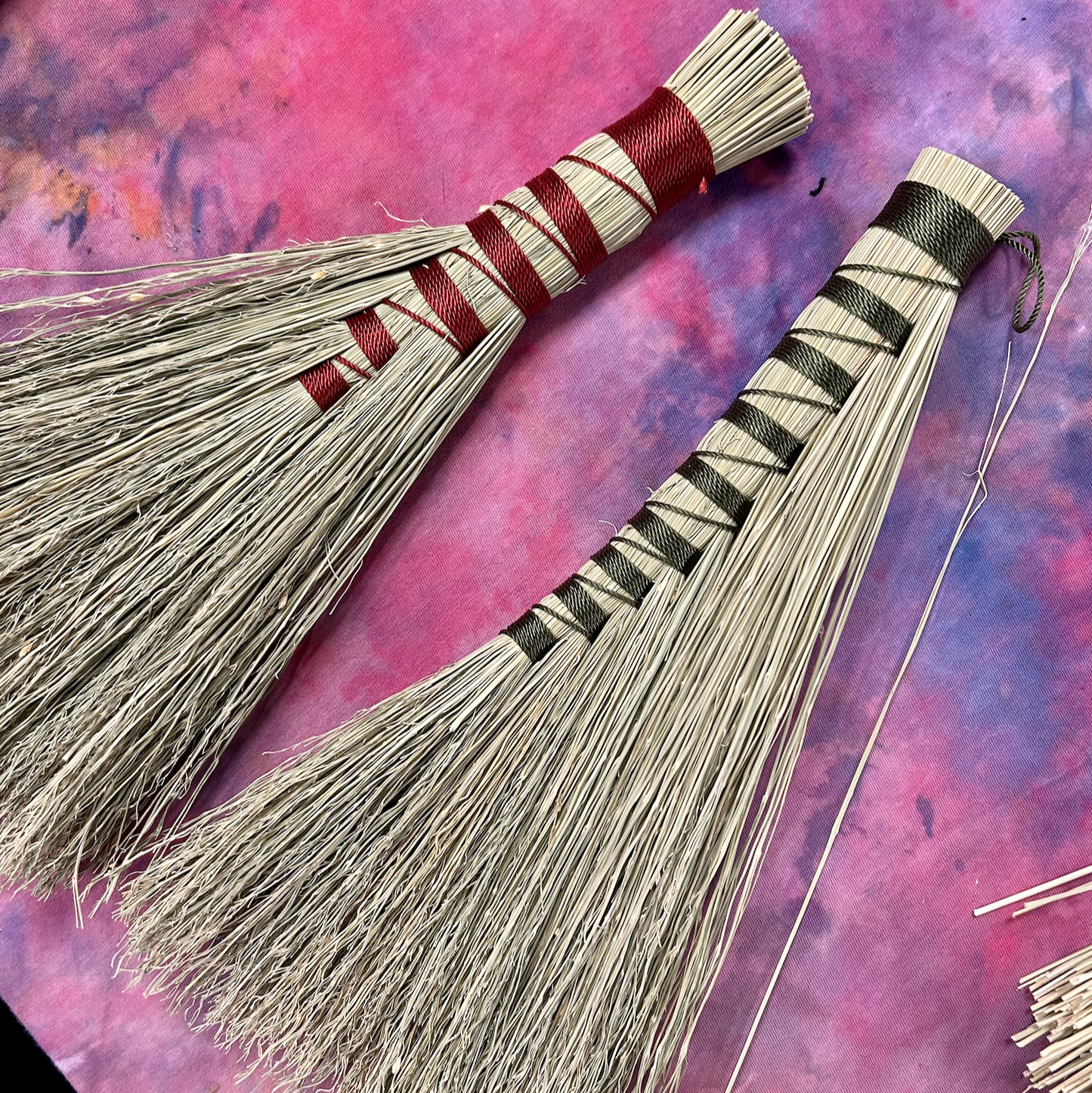Two hand broom examples from class - one with red detail and one with green detail.