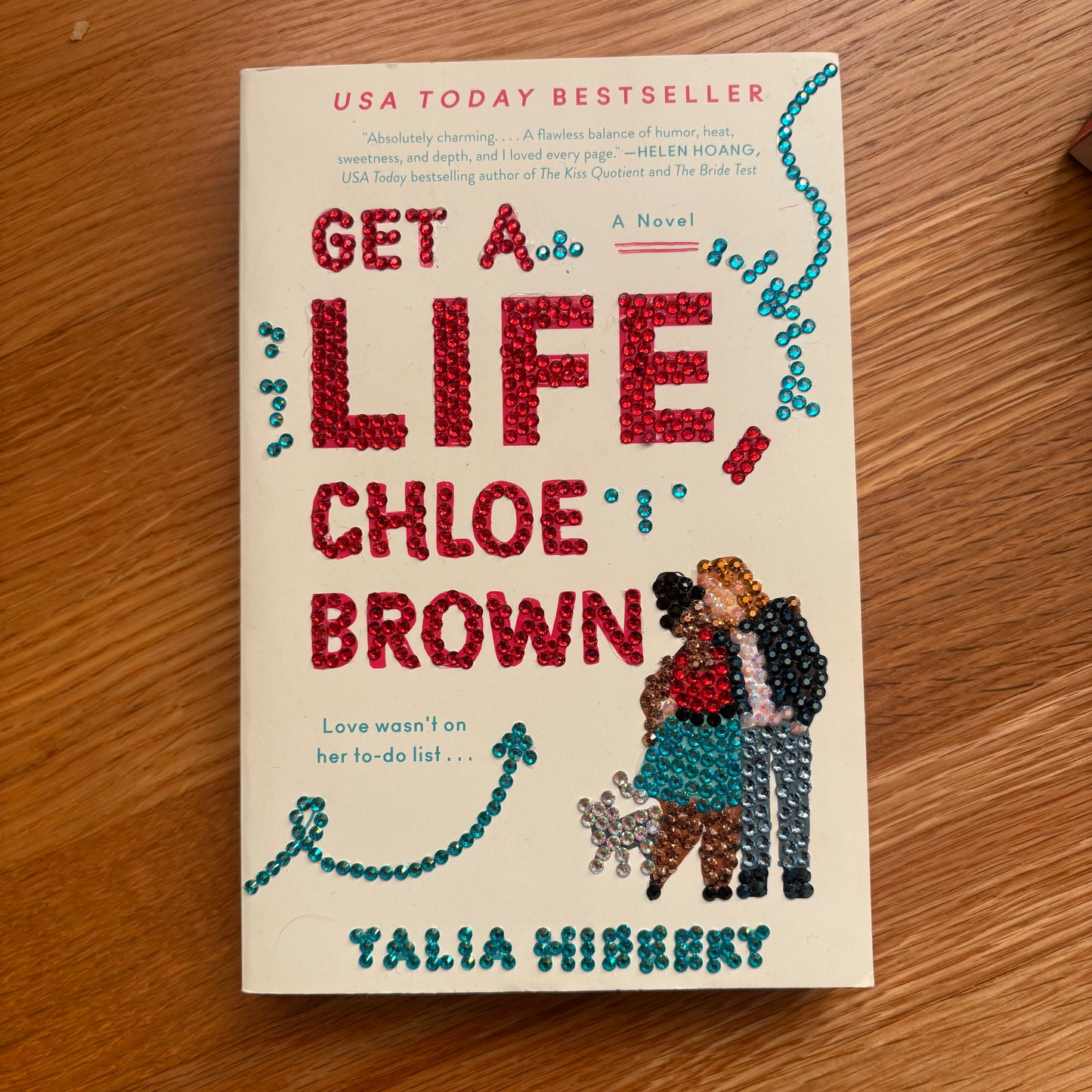 Book titled 'Get a Life, Chloe Brown' by Talia Hibbert on a wooden surface