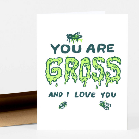 A letterpress greeting card that says "you are gross and I Love you." The word gross is written in dripping neon green letters. There are three flies gathering on it.