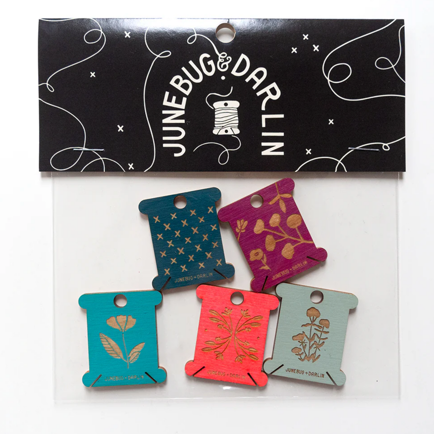 A single packaged batch of five floss holders by Junebug and Darlin.