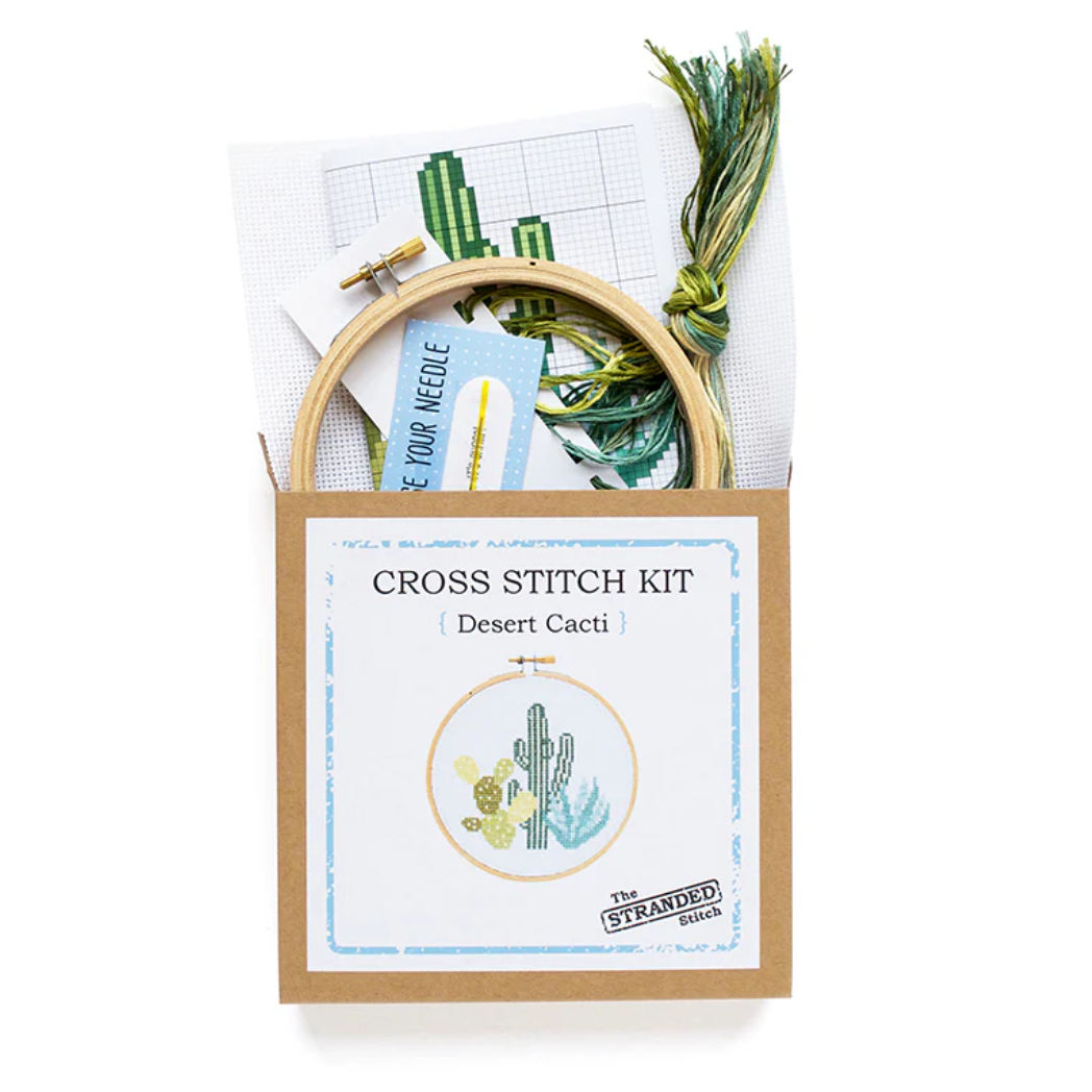 Cross stitch kit with embroidery hoop and materials on a white background