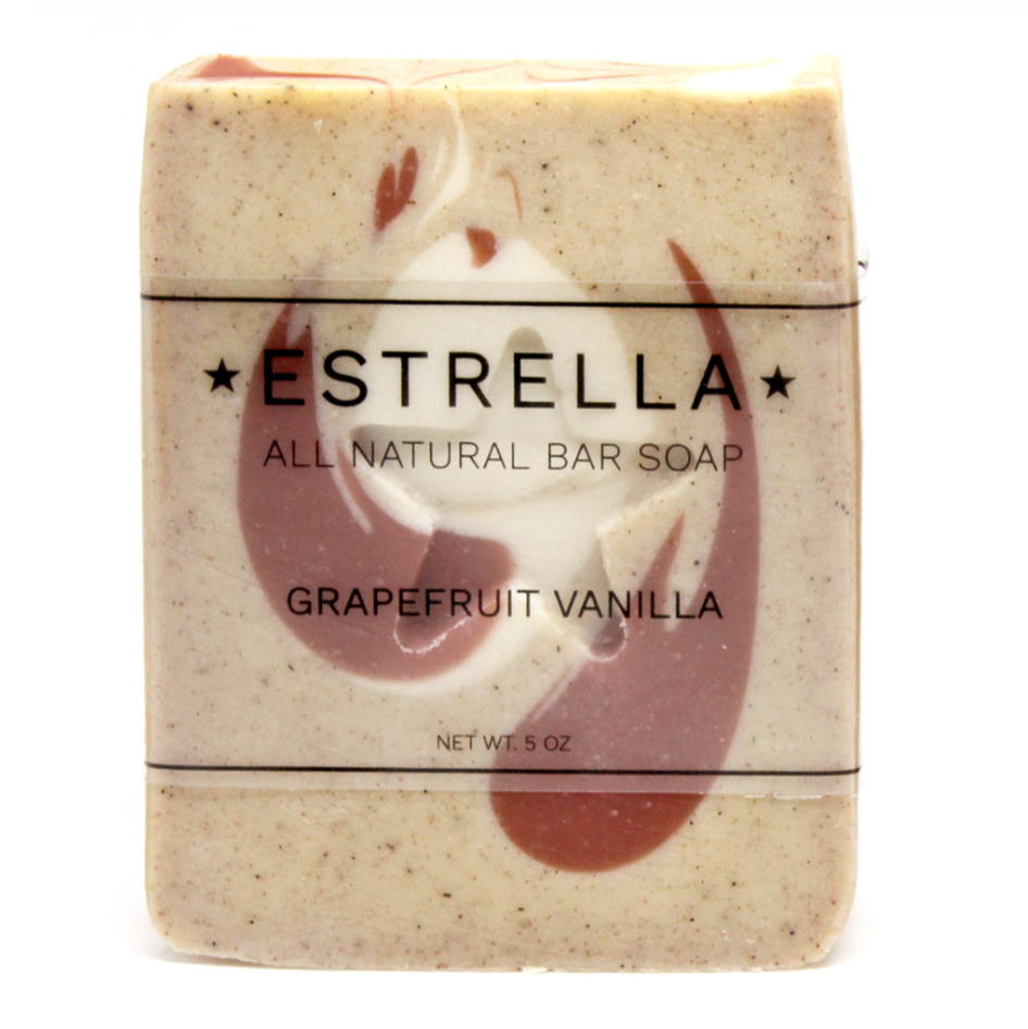 A bar of handmade soap with a beige base and swirled patterns of darker and lighter peach shades, featuring a star shape on top.