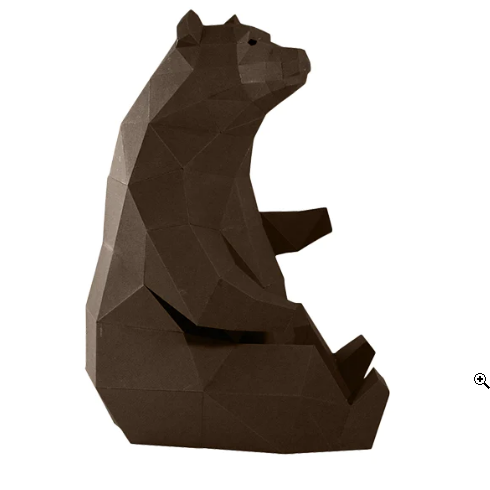An example of a completed paper craft kit of a bear sitting down against a white background.