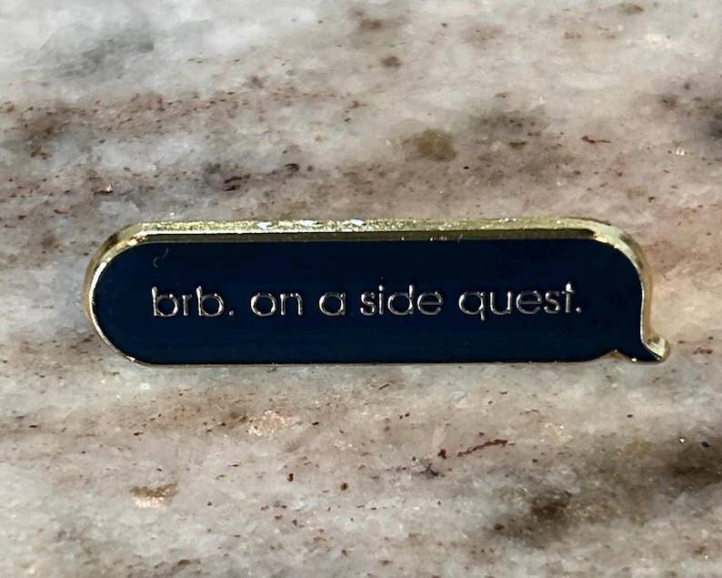 Side Quest Enamel Pin Navy Blue Gold Text Message Pin for Gamers and Book Lovers