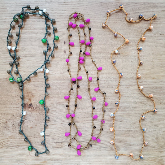 Three examples of beaded crochet necklaces. Green, Pink and Gold. 