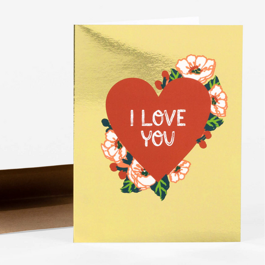 Gold foil card with red heart in the center with pretty flowers growing out of the sides. 