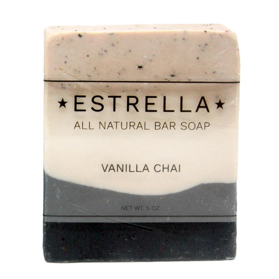 A bar of Vanilla Chai scented Estrella handmade soap. It has three stripes: textured oatmeal at the top, solid off-white in the middle and dark gray at the bottom. 